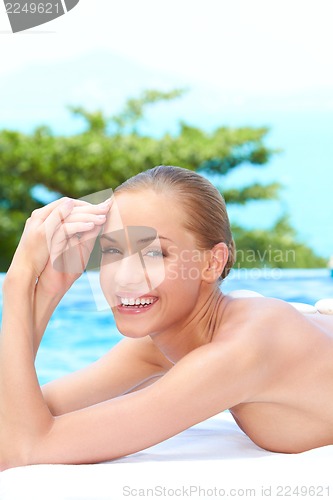Image of Woman during spa treatment next to pool