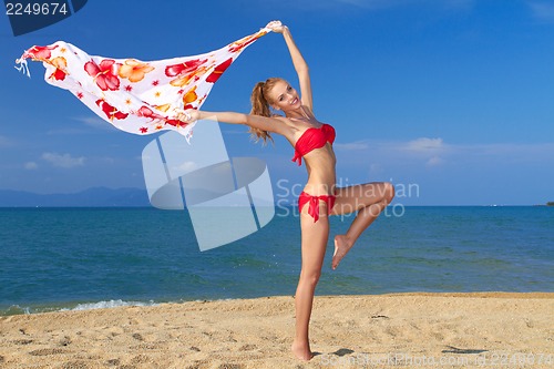 Image of Happy young woman with scarf on tropical beach