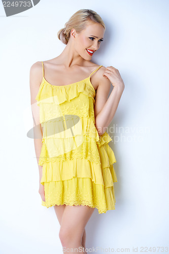 Image of Sexy blond woman in yellow dress