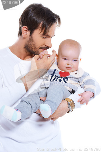 Image of Young father cradling his baby on his arm