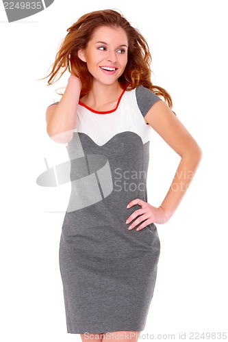 Image of Cute young woman in gray dress on white