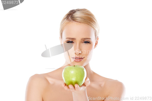 Image of Happy and healthy woman holding apple