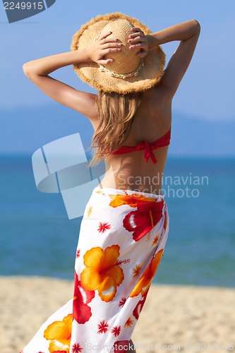 Image of Woman in sarong and straw hat