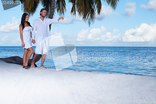 Image of Couple nex to Palm tree