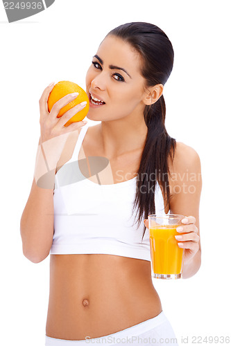 Image of Woman holding glass of fresh orange and glass of juice