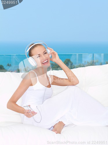 Image of Vivacious woman listening to music