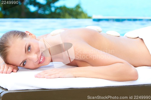 Image of Beautiful woman lying on spa bed at outdoor