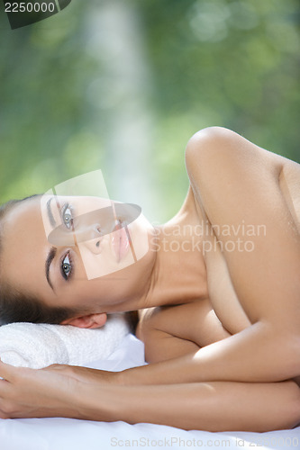 Image of Beautiful woman is resting on spa bed