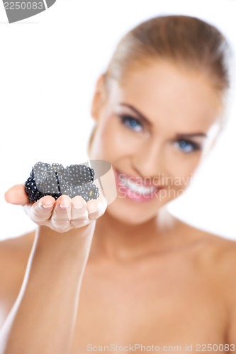 Image of Smiling girl holding blackberries on hand