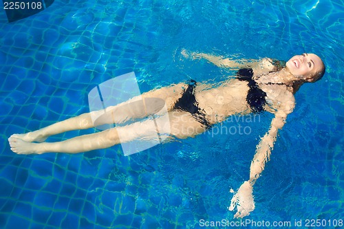Image of Happy Woman Floating In Pool