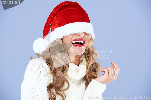 Image of Sexy smiling woman blinded by Red Santa hat