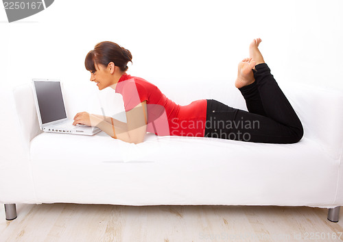 Image of Girl with laptop on couch