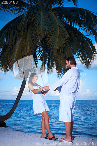 Image of Couple nex to Palm tree