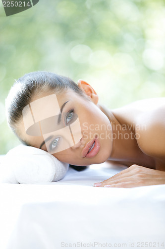 Image of Beautiful woman is resting on spa bed