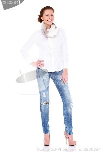 Image of Young sexy brunette woman in white shirt and blue jeans