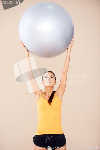 Image of Woman doing exercises with fitness ball