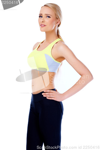 Image of Sexy and slim blond woman standing on white