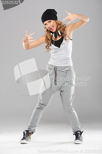 Image of Female modern dancer posing on grey
