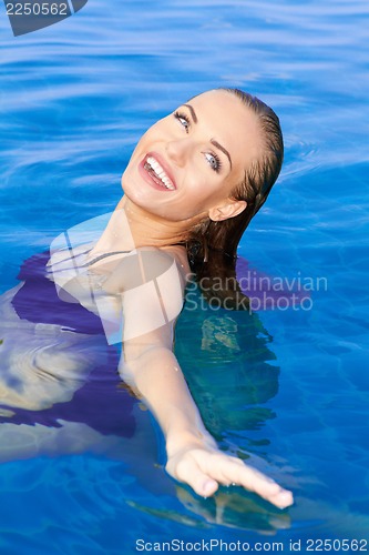 Image of Beautiful Woman Relaxing In Pool