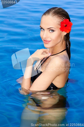 Image of Tropical girl with flower on her ear