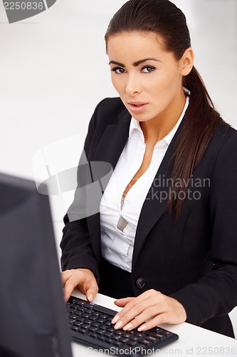 Image of Business woman sitting in front of computer monitor