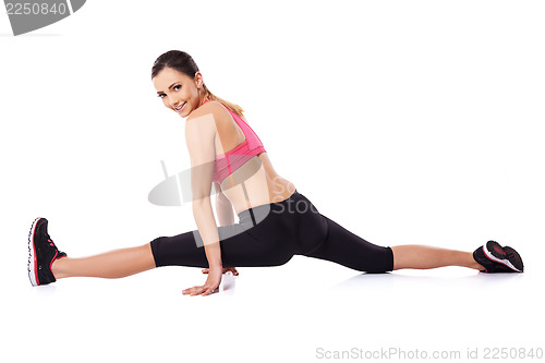 Image of Pretty smiling woman doing the splits