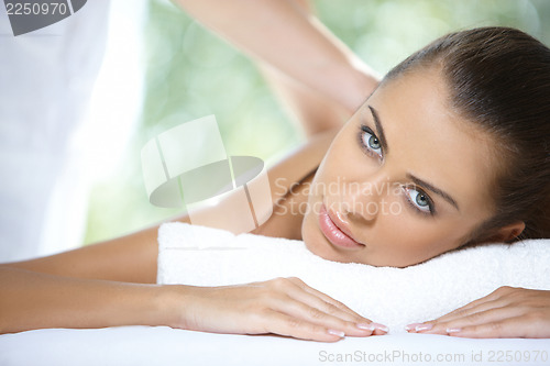 Image of Beautiful woman is resting on spa bed