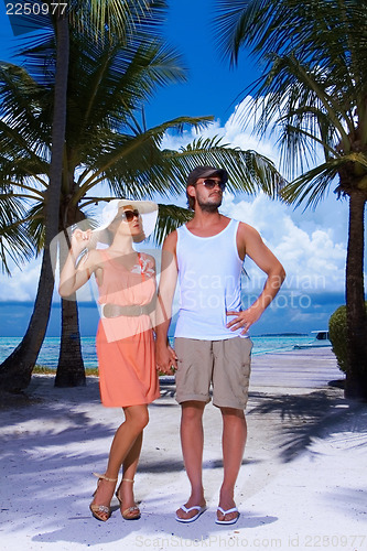 Image of Couple nex to Palm tree