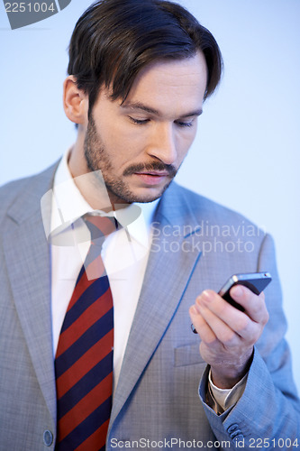 Image of Man reading a text message on his mobile