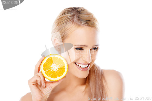 Image of Blond woman with beautiful smile holding orange