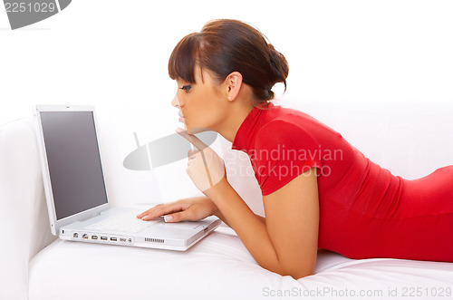 Image of Girl with laptop on couch