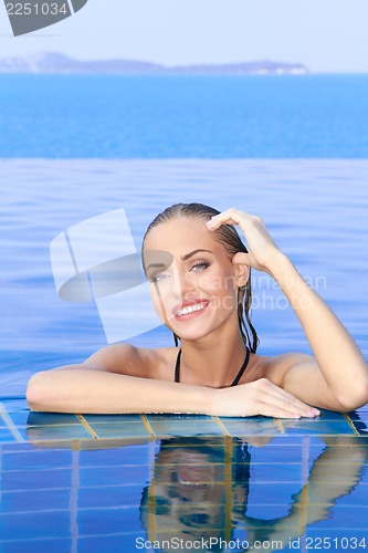 Image of Smiling Woman Reflected In Pool