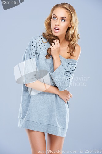Image of Portrait of cute young female posing on gray