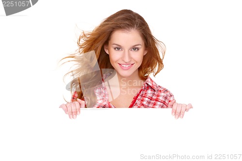 Image of Young woman in casual clothing holding empty board