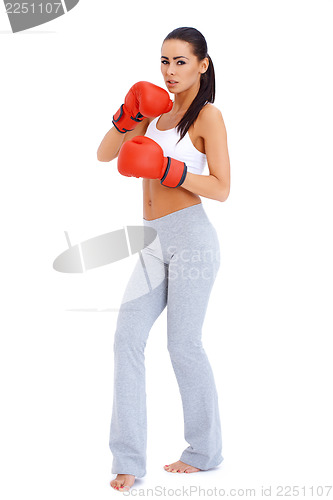 Image of Full body shot of a woman wearing boxing gloves