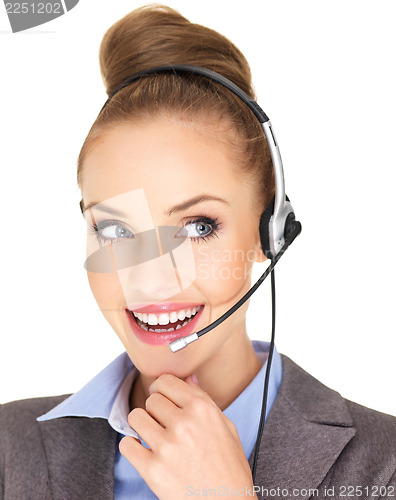 Image of Pretty female businesswoman talking headset