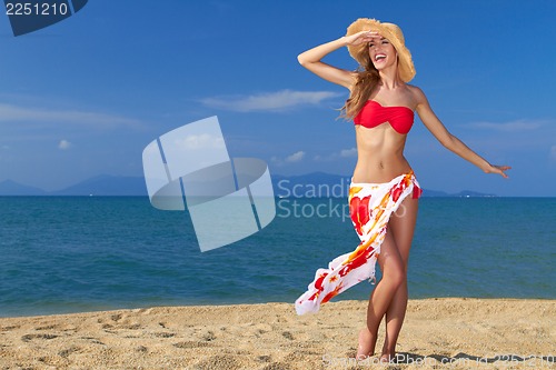 Image of Girl wearing bikini and hat, posing at the beach