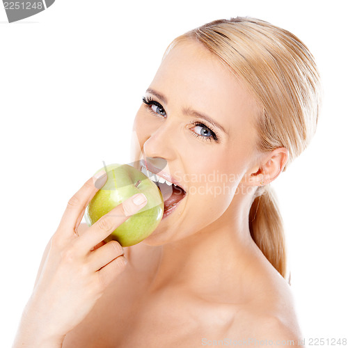 Image of Beautiful girl is biting fresh apple