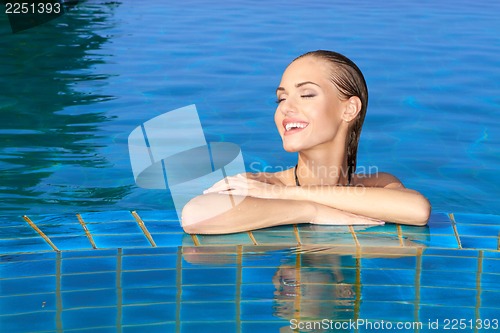 Image of Smiling Woman Reflected In Pool