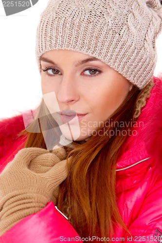 Image of Young woman wearing winter jacket scarf and cap