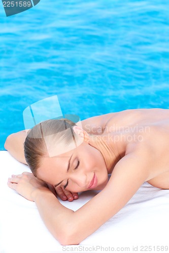Image of Woman during spa treatment next to pool