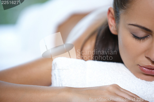 Image of Beautiful woman is resting on spa bed