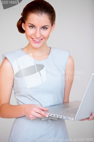 Image of Young attractive business woman with laptop computer