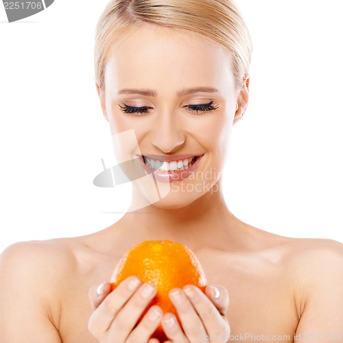 Image of Smiling girl is holding fresh orange