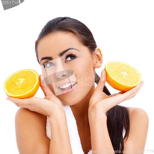 Image of Woman with fresh orange halfs in her hands