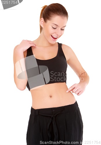 Image of Woman checks the waist fatness on white