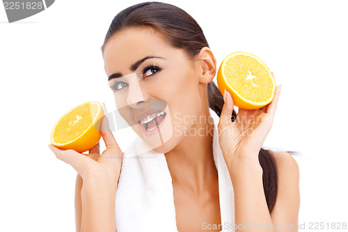 Image of Woman with fresh orange halfs in her hands