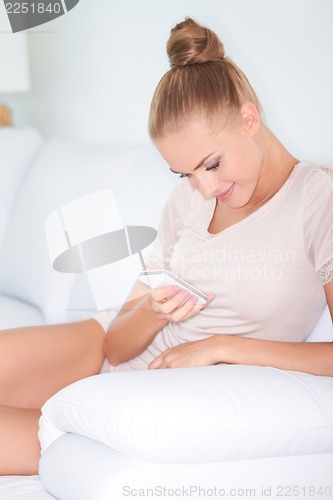 Image of Beautiful woman texting on mobile