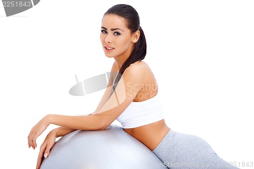 Image of Cute brunette relaxing after exercises