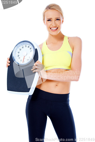 Image of Smiling woman holding a waight scale